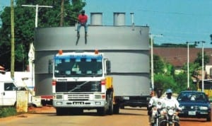 An articulated vehicle carrying an industrial tank on Warri-Efunrun Road in Delta State last Sunday. Photo: NAN