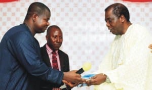 Managing Director, News Agency of Nigeria, Mr Ima Niboro (left), handing over keys of an ultra-modern United Believers Mission Church building erected by him to the General Overseer, Pastor Augustus Owraigbo (right), during the hand-over and dedication of the church building in Delta State last Saturday. With them is the Chairman, Bible Truth Ministry, Pastor Vincent Omugbe. Photo: NAN