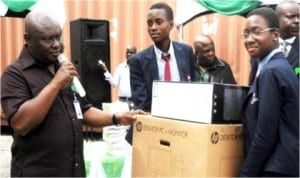  Rivers State Resident Electoral Commissioner, Mr Aniedi Ikoiwak (left) presenting the winning prize to representatives of Model Secondary School, GRA,Port Harcourt, Master Okoimisi Ignatius and Miss Dominic-Kalio Mercy at the INEC Rivers Voter Education Quiz Competition for selected secondary schools in Rivers, yesterday