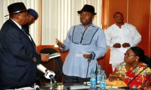  L-R: Minister of State for Niger Delta, Mr Darius Dickson-Ishaku, with  the  book titled 'Emerging Issues in Niger Delta and True Federalism' presented by   leader of delegation, Niger Delta Peace Initiative, Mr Julius Enehikuere,  during their visit to the Minister of State for Niger Delta Affairs in Abuja last  Thursday. With them is Director, Community Development and Education, Mrs Godiya Yohanna. Photo: NAN