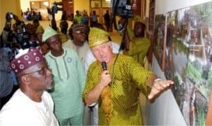 Governor Idris Wada of Kogi State (left), being shown a pictorial collage of the  Revitalized ECWA Hospital by the Revitalization Committee, Mr Don Campion, whose  missionary father, Dr George Campion, set up the hospital about 50 years ago, at the  inauguration in Egbe, Kogi State, recently.