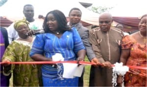 Rivers State Commissioner for Information and Communications, Mrs Ibim Semenitari (2nd left) cuts the tape to commission the Destiny Skills Acquisition Centre, Okujagu near Port Harcourt, yesterday. She is assisted by President, Mark of Destiny Mission, Pastor Bridget Okujagu (left), Project Visioner, Mrs Jokotade Adamu (right) and others