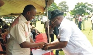 Rivers State Governor, Rt. Hon. Chibuike Amaechi, receiving an address from Chairman TUC, Comrade Chika Onuegbu, during the May Day Celebration 2014 in Port Harcourt, yesterday.