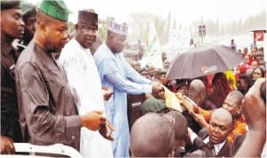 L-R: Deputy Speaker House Of Representatives, Rep. Emeka Ihedioha; Senate President, David Mark And Speaker House Of Representatives, Rep. Aminu Tambuwal Under Heavy Rain At National Assembly To Receive Women For Peace Who Were Protesting The Abduction Of School Girls In Chibok Borno State In Abuja On Wednesday.