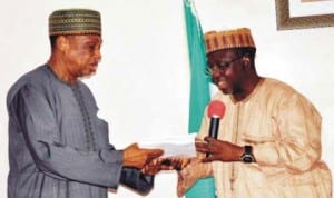 Chairman, Senate Committee on Security and Intelligence, Senator Mohammed Magoro (left), receiving copies of White Paper on the Judicial Commission of Inquiry into Alakyo killings in Lafia, recently.