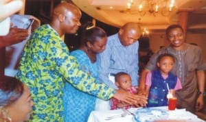 Deputy Speaker, Rivers State House of Assembly, Hon. Leyii Kwanee (right), State Chairman, Nigeria Union of Journalists (NUJ), Mr Opaka Dokubo (left), assisting a member of the Assembly’s Press Corps, Mr Ruskin Amadi and his family to cut his 50th birthday cake in Port Harcourt last Monday. Photo: Chris Monyanaga