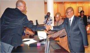 Governor Chibuike Amaechi Congratulating Mr Tom Jackson Orage, immediately after his swearing-in as a member of the State Judicial Service Commission in Port Harcourt. 