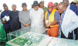 President Goodluck Jonathan (4th left) inspecting the model of NIMASA Shipyard, Dockyard and Nigeria Maritime University, Okerenkoko, at the Groundbreaking ceremony in Warri, last Saturday.With him are: Gov Emmanuel Uduaghan of Delta State (right) Gov. Willie Obialor of Anambra State (3rd l)  and other dignitries.