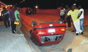 A car that skidded off the Road on Airport Road in Abuja, recently. Photo: NAN.