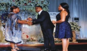 Mrs May Okokpa (left), presenting an Award of Heart of Gold  to Austine Baribor Gbaraba (middle), during Red Ball 2014 in support of Diabetes Management, Awareness and Prevention organised  by Eve Afrique magazine in Port Harcourt last Sunday.  With them is Gbaraba’s wife. Photo: Dele Obinna