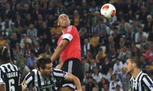 Benfica’s captain, Luisao in aerial contest with Juventus players during the semi-final stage of the UEFA Europa Cup in Turin, Italy