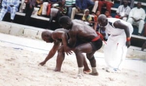 Traditional wrestles, Yakubu Adamu (right) and Yellow Tuwon (middle), slugging it out in Port Harcourt.