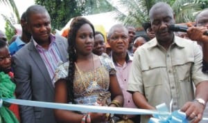 Senator Magnus Abe flanked by his wife, Bariyaah and Chairman, Gokana Local Gov’t Council, Ledee Demua (1st left), cutting the tape to inaugurate a Neighbourhood Water Scheme in Giokoo Community of Rivers State, recently. Photo: NAN