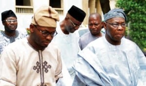 Former President Olusegun Obasanjo (right)with the son of late  Alhaji Azeez Arisekola Alao, Alhaji Yisa Arisekola Alao, during his visit to the family in Ibadan, last Saturday. Photo: NAN