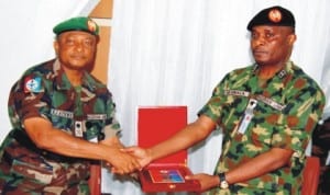 Commander, Joint Task Force (Jtf) in the Niger Delta, Maj.-Gen. Emmanuel Atawe (left), presenting a plaque to visiting Army Chief of Training and Operations, Maj.-Gen. Ebibowei Awala, at Jtf’s headquarters, Opollo in Yenagoa last Wednesday. Photo: NAN
