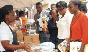 Sisterly Rosma (left) explaining the functions of a Halogen Oven to representative of General Manager, Lagos Environmental Protection Agency, Mr Bakare Olatubosun; Zonal Director, Federal Ministry of Environment (FME), Mrs Oluwatoyin Agbenla, former Federal Controller,Pollution Control and Environmental Health, Mrs Olufunke Babade and Deputy Director, Education Control and Environmental Health, Mrs Odulami Adetutu, at the World Environment Day in Lagos last Thursday. Photo: NAN.