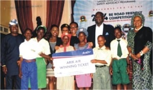 Lagos Commissioner for Transportation, Mr Kayode Opeifa (1st left), Governot Babatunde Fashola (3rd-right), Commissioner for Education, Mrs Olayinka Oladunjoye (right) and winners of the finals of "be Road Friendly" competition in Lagos 