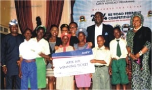Lagos Commissioner for Transportation, Mr Kayode Opeifa (1st left), Governot Babatunde Fashola (3rd-right), Commissioner for Education, Mrs Olayinka Oladunjoye (right) and winners of the finals of "be Road Friendly" competition in Lagos