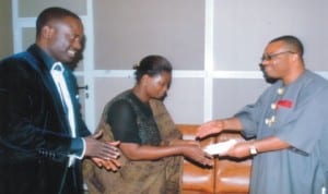 General Manager, Rivers State Newspaper Corporation (RSNC), Mr Celestine Ogolo(right), presenting a souvenir on behalf of Wisdom to Wealth and Development Foundation to the beneficiary of the initiative, Mrs Gloria West, during a courtesy visit to the corporation. With them is Niger Delta Coordinator, Wisdom to Wealth and Development Foundation, Prince Anyanate Kio, yesterday. Photo: Egberi A. Samspson