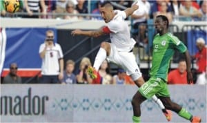 USA’s Clint Dempsey (left) powers past Nigeria’s Juwon Oshaniwa, during an international friendly between USA and Nigeria at the weekend
