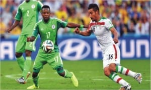 Super Eagles’ Ogenyi  Onazi (17) in contest with an Iranian opponent in Curitiba, Brazil last Monday