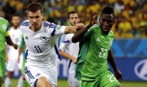 Super Eagles player (right),  struggling to beat Bosnia defender in the ongoing World Cup in Brazil