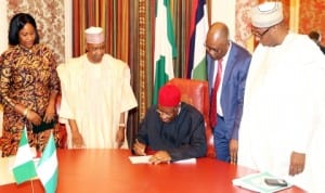 President Goodluck Jonathan (middle) signing the 2014 Pension Reform Bill into Law at the State House in Abuja last Tuesday. With him are Vice President Namadi Sambo (2nd left), Director-General, National Pension Commission, Ms Chinelo Anohu-Amazu (left), Minister Of Justice, Mohammed Adoke (2nd right) and PDP National Chairman, Alhaji Adamu Mu’azu.