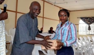 Mr Hawkins Ide,  Ag. Director, Administration, Ministry of Information and Communications, presenting a souvenir to Miss Judith  Amadi of Holy Rosary College at the 2014 Ana/Yusuf Ali Annual Schools Literary Awareness Campaign in Port Harcourt, recently. Photo: Ibioye Diama