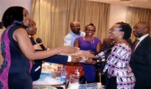 Charter President, Rotary Club of Airfield, Rotarian Nma Onuigbo (left), presenting a souvenir to the wife of Rotarian Innocent Iyalla Harry (2nd right), during Rotary Club of Airfield Charter Certificates presentation ceremony at Novotel Hotel, Port Harcourt recently. Photo: Chris Monyanaga