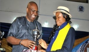 Euphoria Michael (right) receiving a trophy at Dowen College, Lagos for emerging the best graduating student 2014 at Dowen College, Lagos from Mr. Godwin Poi, GM Human Capital Development, RSSDA.  