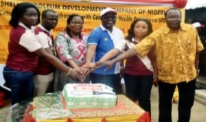 L-R: Shell Petroleum Development Company Research Adviser on Community Health Department, Dr Atom Udo, Chief Medical Director, Obio Cottage Hospital, Dr Umejiego Chidozie, Dr Alasia Osuoabo of Rivers State Health Management Board, SPDC Regional Community Health Management Leader, Mr Edet Edet, SPDC spokes person, Mrs Gladys Afam-Anadu and SPDC Public Health Adviser to Industrial Hygiene, Dr Akin Fajola, jointly cutting the 4th Anniversary cake during a Community Health Insurance Scheme in Port Harcourt last Saturday. Photo: Nwiueh Donatus Ken