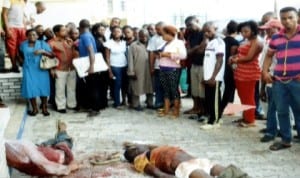 Sympathisers viewing the lifeless bodies of armed robbers  at the premises of The Tide newspapers, Port Harcourt last Monday