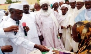 Governor Aliyu Wamakko of Sokoto (right), presenting rice and cash to the needy in Sokoto last Saturday.