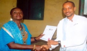 Vice Principal, (Academics), Community Boys Secondary School, Elelenwo, Port Harcourt, Dikio Esther Minaibiye (left), presenting an award to the best performed teacher, Mr. Bellgam Ferdinard .A, during  prize giving/cultural day ceremony last Friday. Pix: Egberi .A. Sampson.