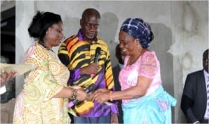 Wife of the Rivers State Governor, Dame Judith Amaechi presenting certificate of participation to one of the women at the Obio/Akpor Empowerment ceremony while Government House Chief of Staff,Tony Okocha watches.