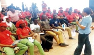 Programme analyst, United Nations Population Fund (UNFPA), Tochie Odele (right), addressing youths during a Town Hall meeting in Abuja recently. 