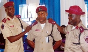 FRSC Deputy Route Commander, Mr Stanley Onyebuchi, being decorated by Anambra Sector Commander, Mr Hyginus Omeje (left) and Sector Head of Operations, Mr Jones Malomo, in Awka last Thursday.