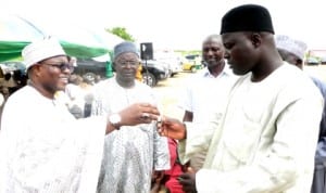 Chairman, Board of Directors, Ashaka Cement Plc, Alhaji Umaru Kwairanga (left), Presenting a key to Danladi Jibir, a Beneficiary to  1 of  the 55 houses built by Ashaka Cement Plc at Ladde-Bage village of Funakaye Lga of Gombe, recently.