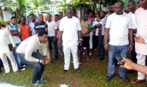 A PDP decampee to All Progressives Congress (APC), Hart Lawson Atemie (left), destroying his PDP membership card in Port Harcourt last Tuesday