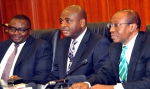 Governor, Central Bank of Nigeria, Mr Godwin Emefiele (right), addressing participants at the Monetary Policy Committee meeting in Abuja, recently.  With him are Deputy Governor, Finance System Stability, Dr Kingsley Moghalu (middle) and Deputy Governor, Corporate Services, Mr Adebayo Adelabu. Photo: NAN