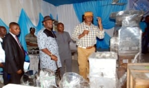 Rivers State Deputy Governor, Engr. Tele Ikuru (centre) listens as Commissioner for Commerce and Industry, Barr. Chuma Chinye, explains functions of some equipment for distribution to beneficiaries