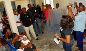 Senior Public Relations Offer of Julius Berger Plc, Abuja, Mrs Grace Ayoola (standing left) Commiunity Liason Officer, Bonny Site, Mr Jephtah Bara-Hart, showing beneficiaries how to use the certified insecticide treated bed nets presented by Juius Berger at the Comprehensive Health Centre, Bonny. With them are Senior Admin Officer, Bonny, Mr Onuma Fenibo and Osuya Obi of the Public Affairs Department.