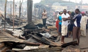 Traders and sympathizers at Aleshinloye market razed by midnight fire in Ibadan recently.