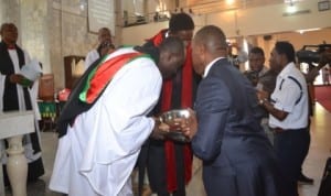 Rivers State State Commissioner for Youth Deveploment, Sir Owene Wonodi (2nd right) presenting a gift to the Canon residentiary of St. Paul’s Anglican Church, Diobu, Rev Canon Kingsley Ogbonda (left), to mark 2014 International Youth Day. Photo: Chris Monyanaga.