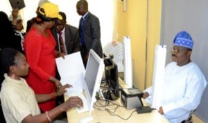 Governor Abiola Ajimobi of Oyo State (right) registering for  National Identity Card in Ibadan, recently. Photo: NAN