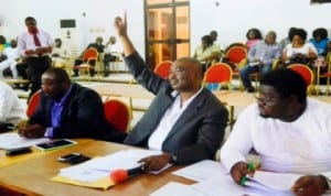 Hon Golden Chioma with his hand up (middle) to contribute to the House matters. With him are Hon. Barr Anabraba Fredrick (right), Hon. Azubuike Nwanjoku (left), at the sitting of the State House of Assembly, last Monday. Photo: Chris Monyanaga 