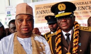 Former Minister of Internal Affairs, Senator Mohammed Magoro (left) with Comptroller General of Immigration, Mr David Parradang, at the 2014 Comptroller-General's Annual Conference in Abuja last Friday. Photo: NAN