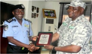 AIG Zone 2 Command, Mamman Tsafe (left), presenting a plaque to the Customs Controller, Federal Operation Unit, Zone A, Mr Turaki Umar, during the Custom’s boss familiarisation visit to the AIG's office in Lagos, recently.