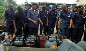 Commander General of Nscdc, Dr Ade Abolurin (3rd left),  inspecting seized jerry cans of petrol from vandals during his tour of Oke-Oko Isawo in Ikorodu, Lagos State  last Friday. Photo: NAN