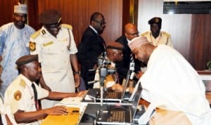 Vice President Namadi Sambo (right) during the capturing of his biodata at the official launching of new e-Passport in Abuja  recently. Photo: NAN